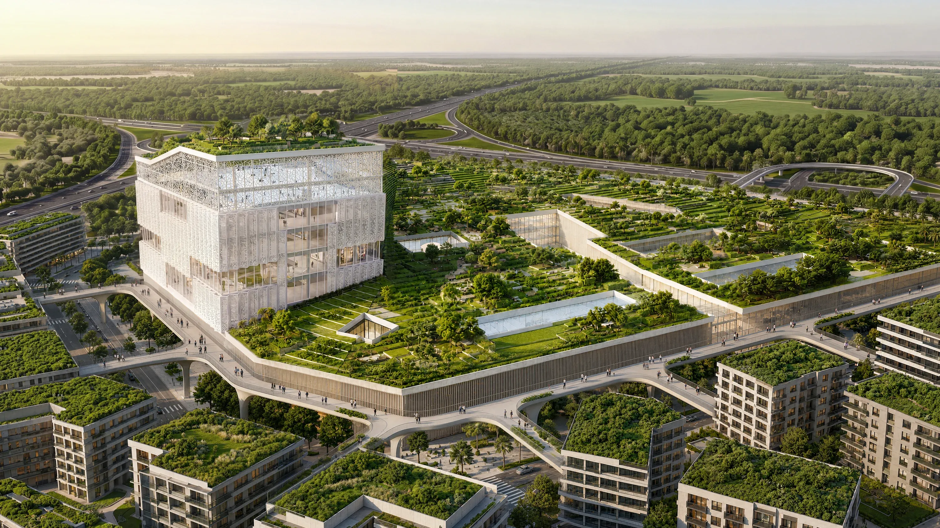 The landmark business hub of Abu Dhabi Mira Hills from the air, a glazed cube above planted terraces beside the highway